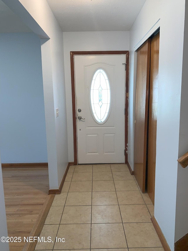 doorway with light tile patterned floors