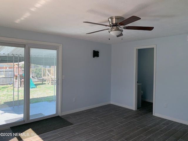 unfurnished room featuring dark wood-type flooring and ceiling fan