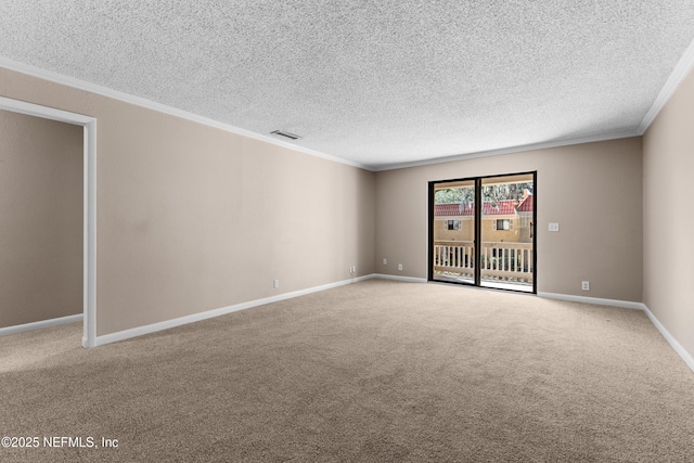 carpeted spare room with ornamental molding and a textured ceiling