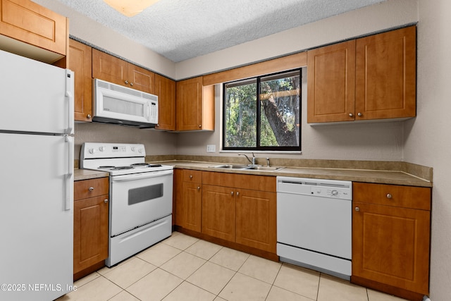 5811 Atlantic Blvd Unit 44, Jacksonville, FL 32207 - kitchen featuring sink, white appliances, a textured ceiling, and light tile patterned flooring