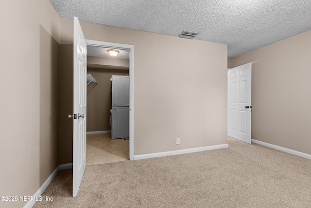 5811 Atlantic Blvd Unit 44, Jacksonville, FL 32207 - unfurnished bedroom with a spacious closet, light colored carpet, a textured ceiling, and a closet