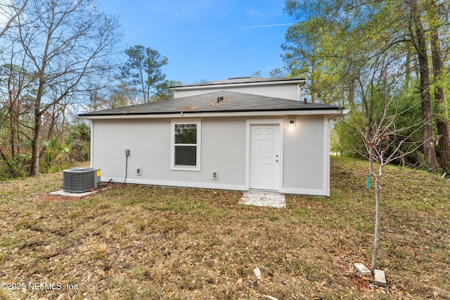 back of property with a yard and cooling unit