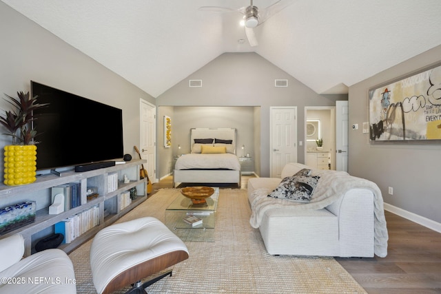 living area with lofted ceiling, visible vents, ceiling fan, and wood finished floors