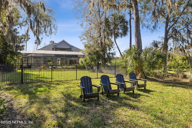 view of yard with a lanai and fence