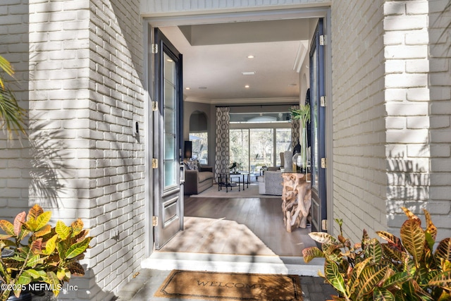 doorway to property featuring brick siding