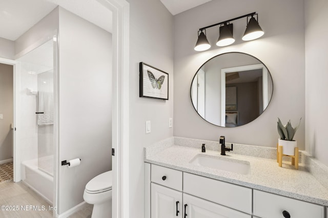 bathroom with toilet, shower / tub combination, baseboards, and vanity