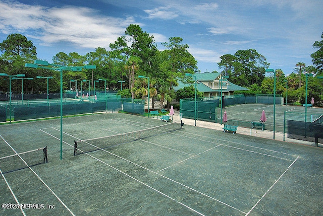 view of sport court featuring fence