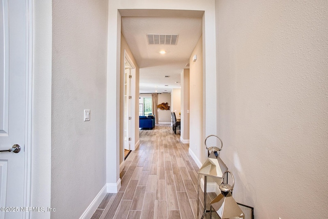 hall with wood-type flooring