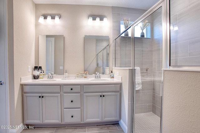 bathroom featuring vanity and a shower with door