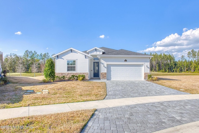 ranch-style house featuring a garage and a front yard