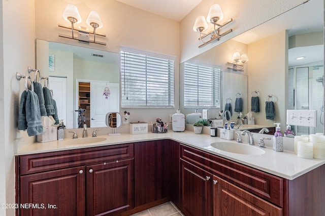 bathroom featuring double vanity, a sink, and visible vents