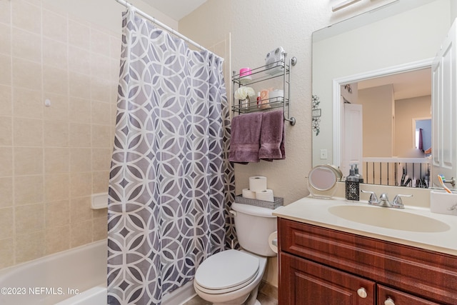 full bath with shower / tub combo, a textured wall, vanity, and toilet