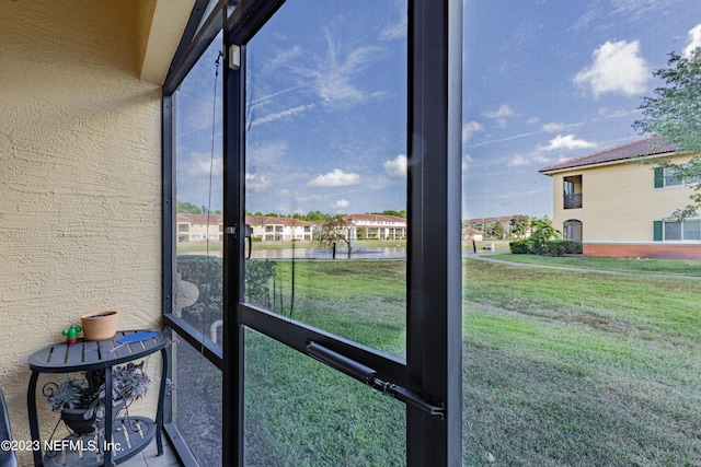 sunroom / solarium featuring a residential view