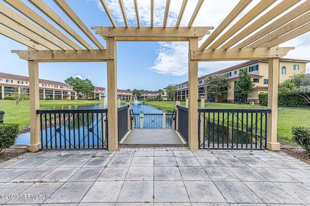 view of patio featuring a water view and a pergola