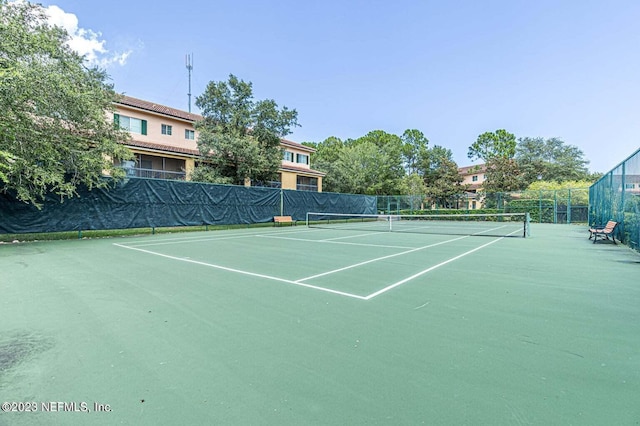 view of sport court featuring fence