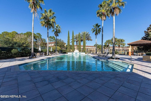 community pool with a patio and a gazebo