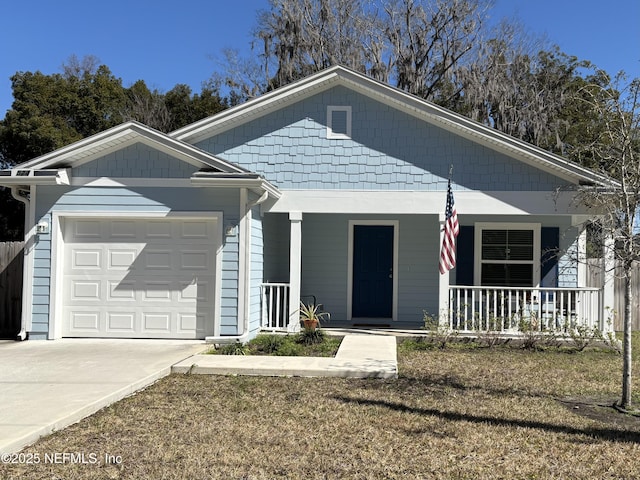 view of front facade featuring a garage, a porch, concrete driveway, and a front yard