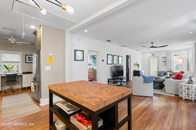 dining area featuring ceiling fan, a healthy amount of sunlight, and light wood-type flooring