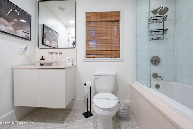 full bathroom with tile patterned flooring, tiled shower / bath, vanity, and toilet