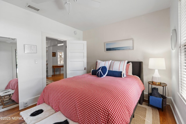 bedroom with hardwood / wood-style floors and ceiling fan