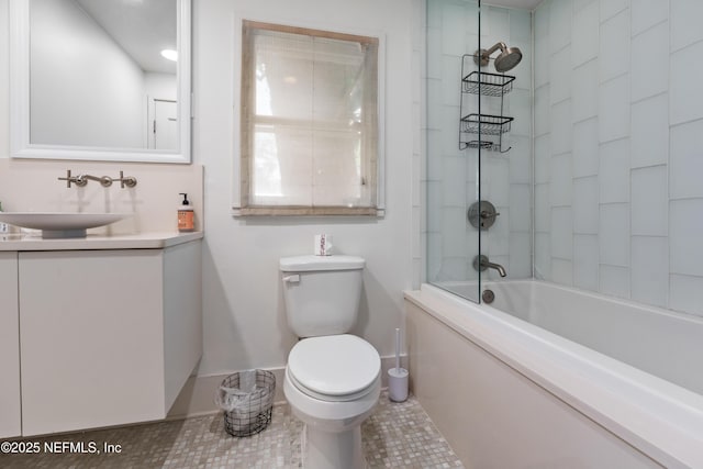 full bathroom featuring vanity, tiled shower / bath combo, and toilet