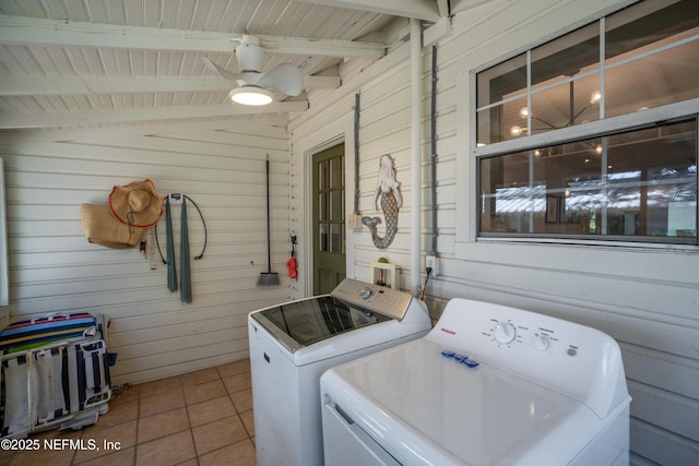 laundry area featuring ceiling fan, washing machine and clothes dryer, wooden walls, and tile patterned flooring