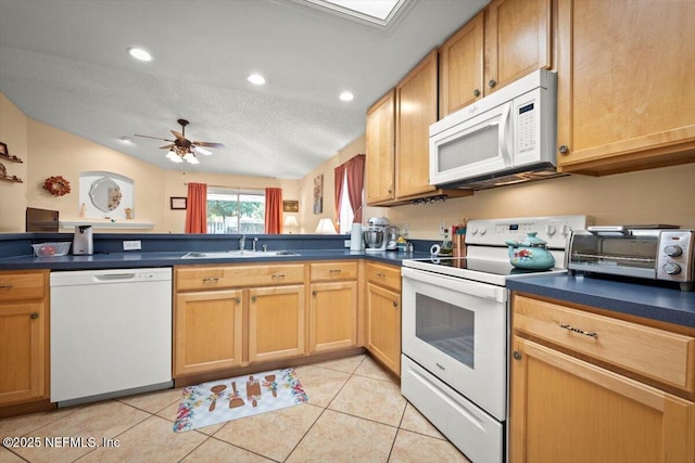 kitchen featuring light tile patterned flooring, sink, white appliances, ceiling fan, and a textured ceiling