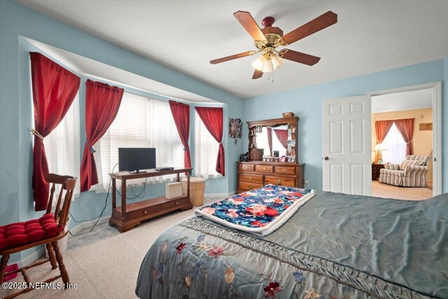 bedroom featuring light colored carpet and ceiling fan