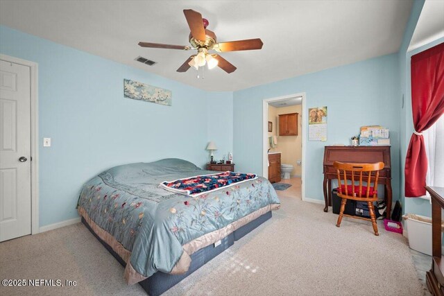 bedroom with ceiling fan, connected bathroom, and light carpet