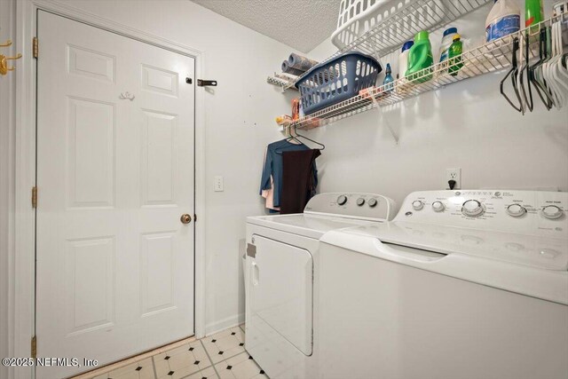 washroom with separate washer and dryer and a textured ceiling