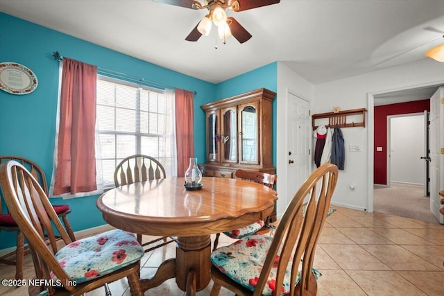 dining area with light tile patterned floors and ceiling fan