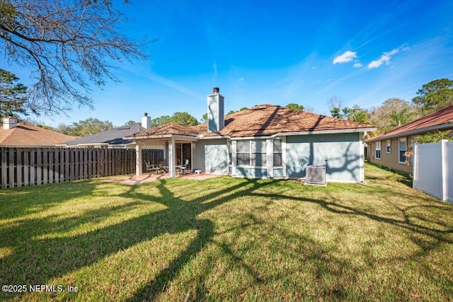 back of house featuring central AC and a lawn