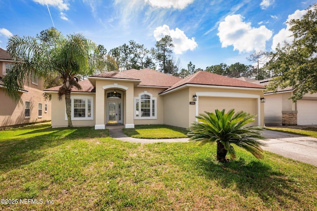 mediterranean / spanish house with driveway, a front lawn, an attached garage, and stucco siding