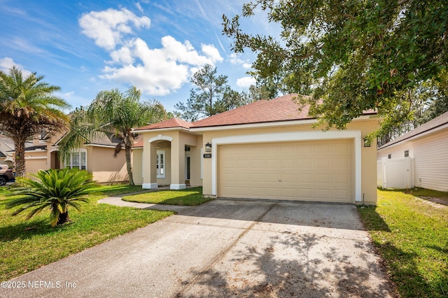 mediterranean / spanish-style home with a garage, a front yard, driveway, and stucco siding