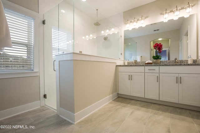 bathroom with vanity and walk in shower