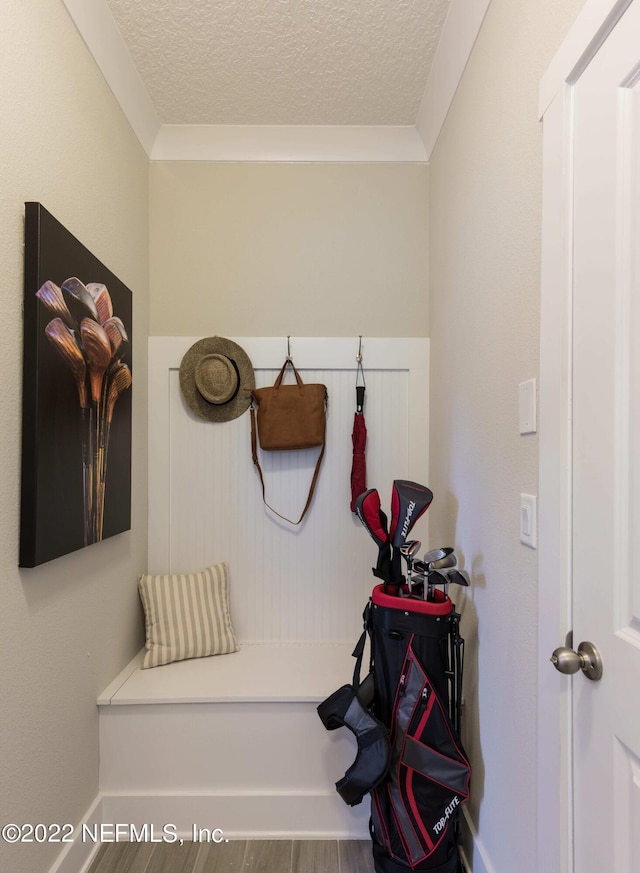 mudroom with wood-type flooring and a textured ceiling