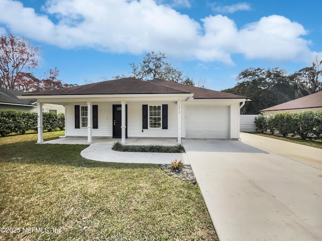 ranch-style house with covered porch, a garage, and a front lawn