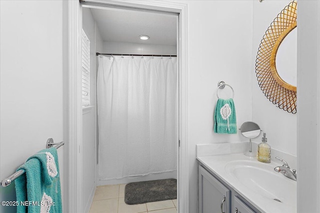 bathroom with a shower with curtain, vanity, and tile patterned floors