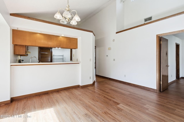 10800 Old St Augustine Rd Unit 301, Jacksonville, FL 32257 - interior space with a notable chandelier, light hardwood / wood-style flooring, and high vaulted ceiling