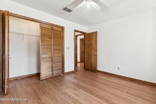 10800 Old St Augustine Rd Unit 301, Jacksonville, FL 32257 - unfurnished bedroom featuring ceiling fan, light hardwood / wood-style floors, a closet, and a textured ceiling