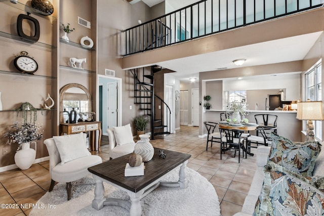 living room featuring a high ceiling and light tile patterned floors