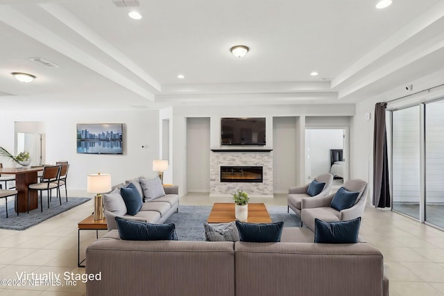 944 Laurel Valley Dr, Orange Park, FL 32065 - living room featuring light tile patterned floors, a raised ceiling, a stone fireplace, and recessed lighting