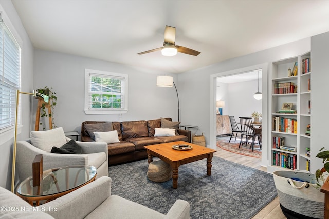 living room featuring ceiling fan and hardwood / wood-style floors