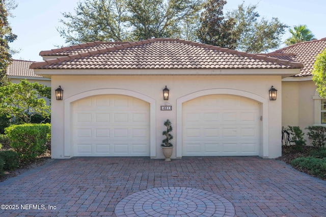 garage with decorative driveway