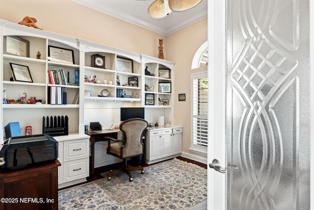 office area featuring ornamental molding, dark wood-style flooring, built in study area, and a ceiling fan