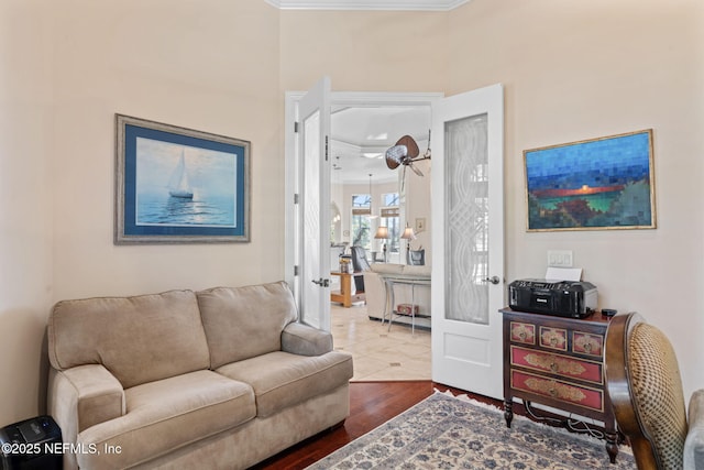 living room with crown molding and dark wood-type flooring