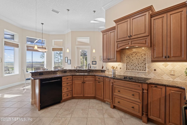 kitchen featuring black appliances, visible vents, brown cabinets, and a sink