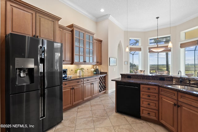 kitchen with tasteful backsplash, a sink, black appliances, and ornamental molding