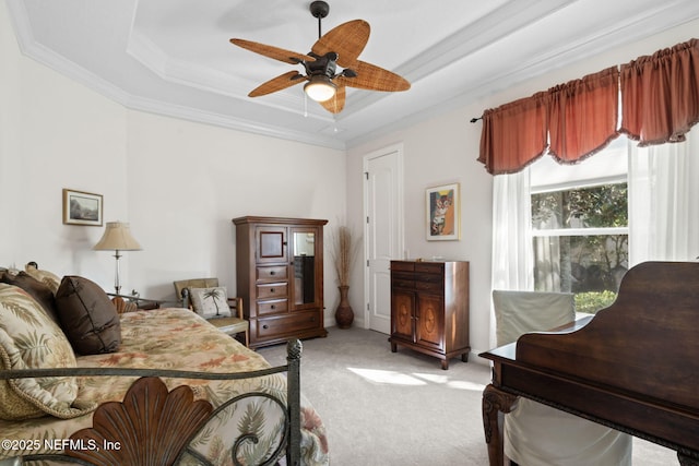 bedroom with light carpet, ceiling fan, ornamental molding, and a raised ceiling