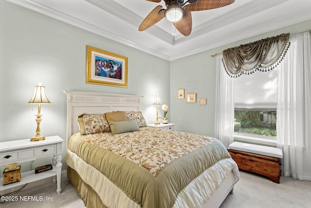 bedroom with ceiling fan, crown molding, a raised ceiling, and carpet flooring